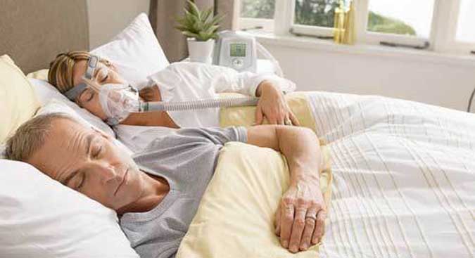 person sleeping with sleep apnea machine