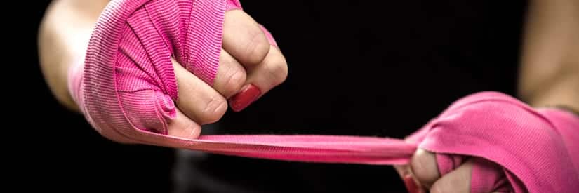 Woman Wrapping Wrists with Pink Boxing Waps