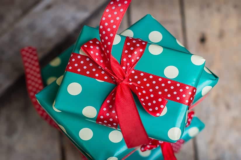 Gifts Wrapped in Green and White Paper with Red Bows