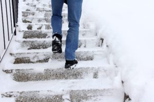 Man Walking up Snowy Stairs