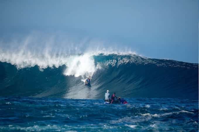 Surfers riding a wave in Maui