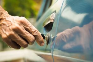 Elderly driver unlocking car door