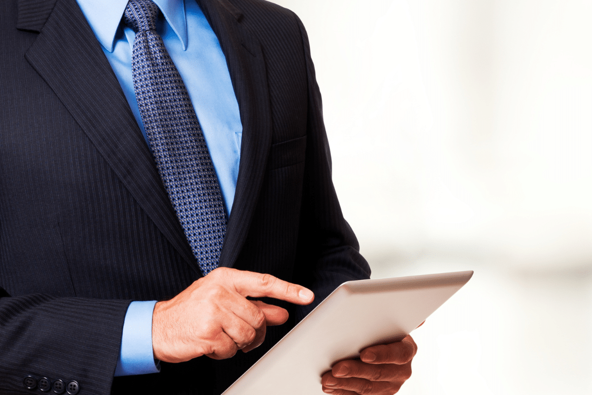 close up business man hands holding tablet